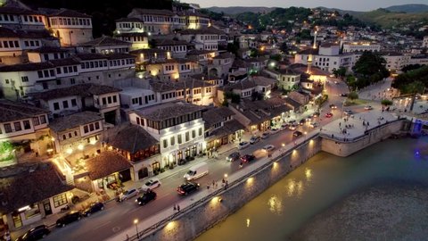 Night view of Berat, Albania. Flying over old houses, city with illumination. Berat is one of the most beautiful cities in Albania