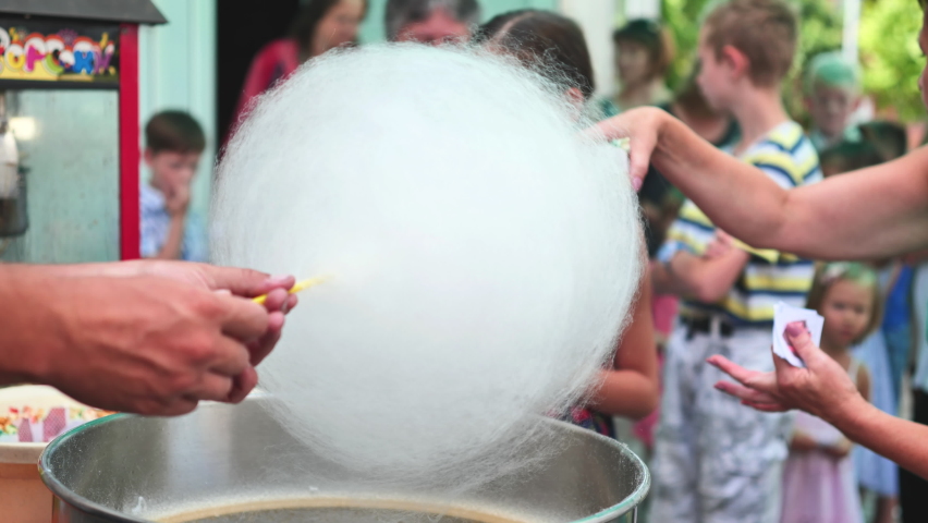 The process of making cotton candy outdoors for children. Royalty-Free Stock Footage #1076200103