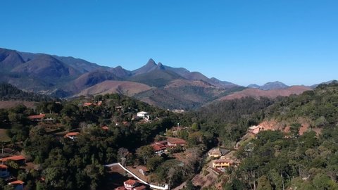 Aerial view of Itaipava, Petrópolis. Mountains with blue sky and some clouds around Petrópolis, mountainous region of Rio de Janeiro, Brazil. Drone photo. Sunny day.