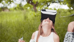 Young woman wearing vr glasses, headset, playing virtual games and watching videos outdoors. Emotions, scared. Close up. Concept of innovation technology, family entertainment, game.