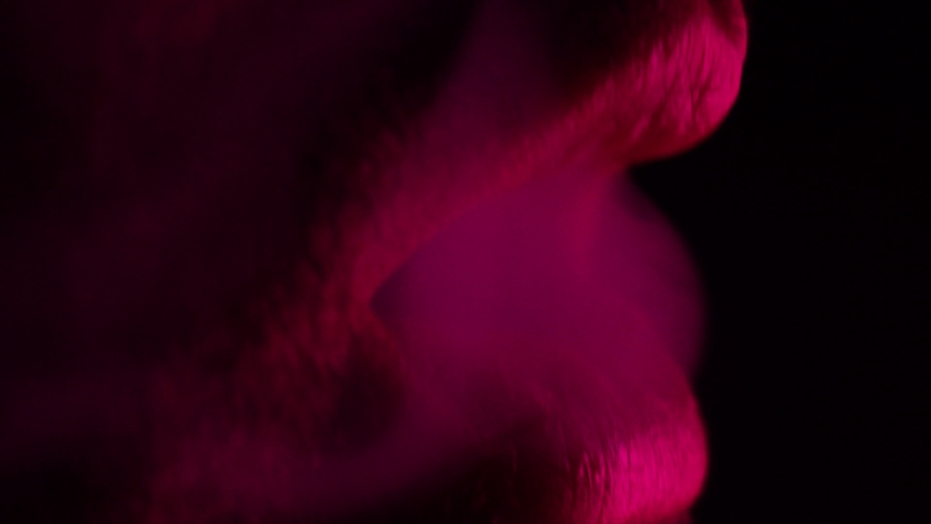 woman is blowing the smoke of hookah. detail , macro 4k slowmotion