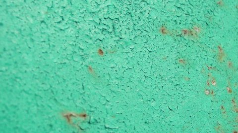 Close-up of a rusty blue paint on metal.