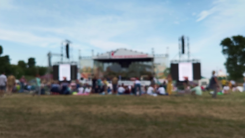 People walking at the festival. The beginning of the concert. Blurred image of people in a festival. Royalty-Free Stock Footage #1076210645
