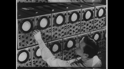 1950s Pittsburgh, PA. Man monitors and adjust a bank of Oscilloscopes. 4K overscan of Vintage Archival 16mm Film Print.