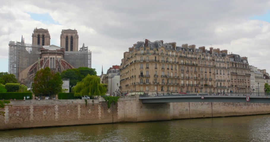 Ile de la Cite with rebuilt Notre-Dame de Paris cathedral beside Seine River in Paris - 4k
