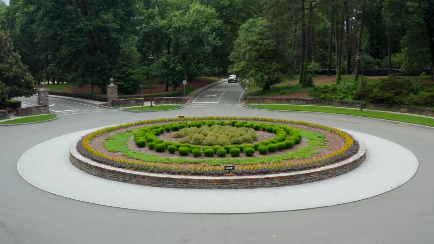 Round flower bed. Landscaped flowers and bushes at roundabout. Traffic circle at Duke University campus.