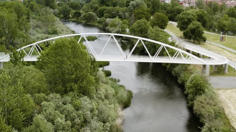 Arched Bridge At Soto Island Nature Preserve Going To Aldehuela Park In Salamanca, Spain. aerial