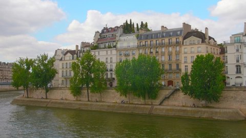 Ile Saint Louis buildings with Quai Orleans Seine River in Paris, France - 4k