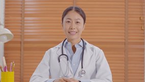 Camera view Asian doctor woman smile meeting online with patient to consult health for healthy wellness life,Smart Doctor wearing white coat with stethoscope Video Call at hospital,Telehealth concept