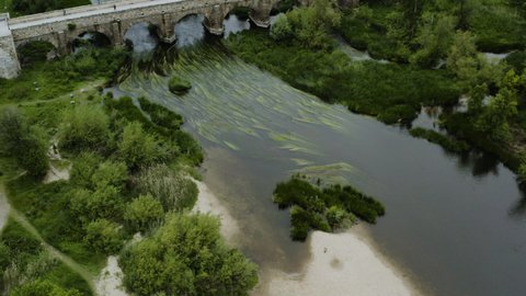 The Historic Roman Bridge Over The Tormes River And The Riverside Parks In Salamanca, Spain. aerial