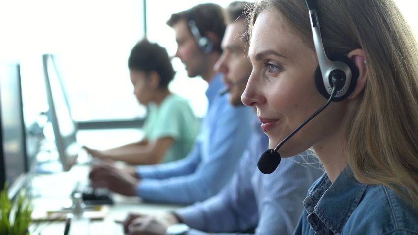 Business woman wearing headset working in office to support remote customer or colleague. Call center, telemarketing, customer support agent provide service on telephone video conference call. Royalty-Free Stock Footage #1076237495