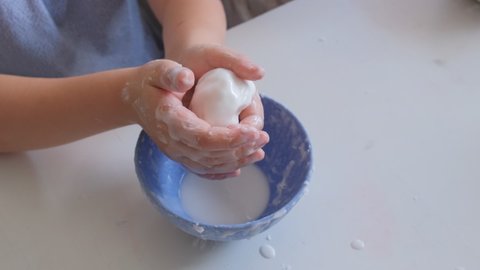 Smart Curious School Kid Playing With Homemade Water and Corn Starch Based Mixture Non Newtonian Oobleck Fluid STEM 