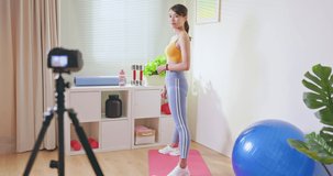 Asian Fitness woman records workout training - Distances exercise through digital camera video tutorial