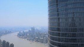 Drone aerial view flying close to modern skyscraper Shanghai downtown. Epic view of Lujiazui and Shanghai. Business economy travel concept b-roll footage office building exterior with modern design