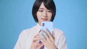 Asian female student using a smart phone.