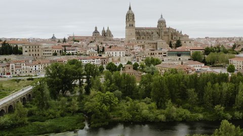 Iconic Landmarks Of Salamanca Cathedral And Roman Bridge In The City Of Salamanca, Spain. aerial