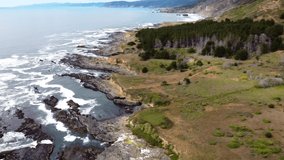4K 30FPS Aerial Footage Oregon Coast - Flying footage (birds eye view) over a coastal shore, natural fjords, pacific northwest forest, ocean waves crash against rocky shore - Epic DJI Drone Video