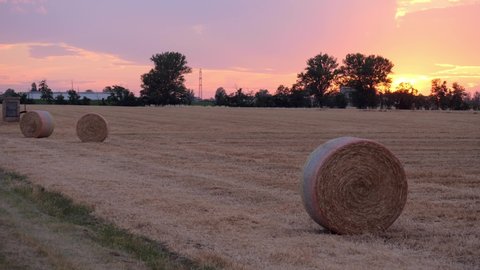 View of Hay Bales in the Countryside during Sunset in Italy