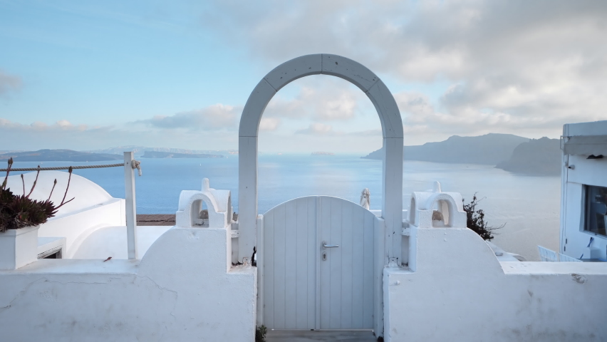 Panoramic view of caldera of Santorini over traditional wooden door | Shutterstock HD Video #1076255150