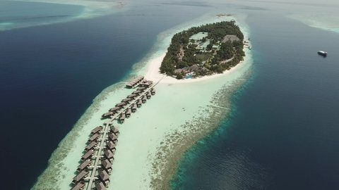 Drone Aerial Video of a tropical resort island on the maldives with palm trees and beautiful beaches