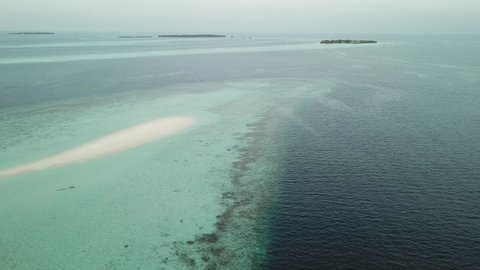 Aerial  Drone Tropical Island on the Maldives with white beaches and azure blue water
