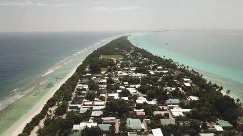 Aerial  Drone Tropical Island on the Maldives with white beaches and azure blue water