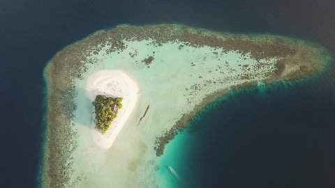 DLOG Flat Island in the sea. Maldives white sand beach tropical islands with drone aerial flying birds eye view with aqua blue sea water and sunny sky