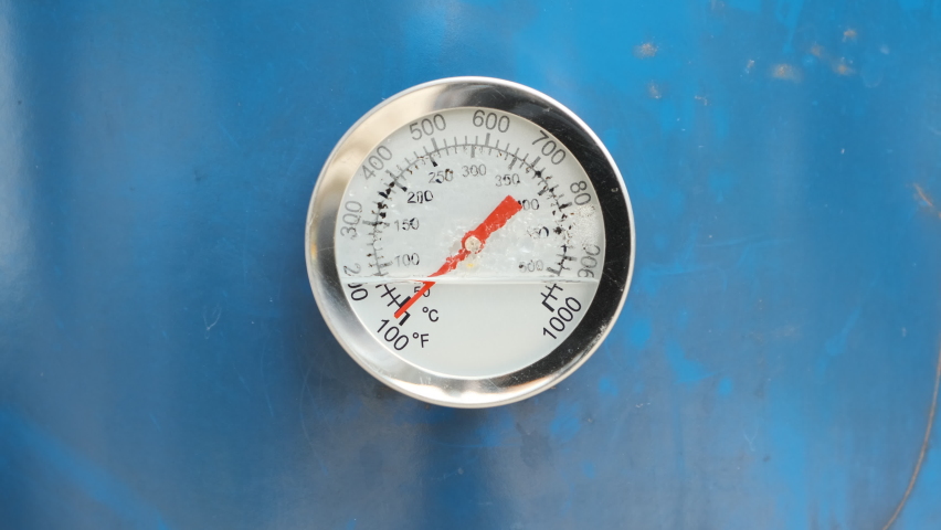 Broken used a Circular Temperature gauge thermometer for measuring hot and steam temperature mounted on blue metal. Industrial concept Royalty-Free Stock Footage #1076266667