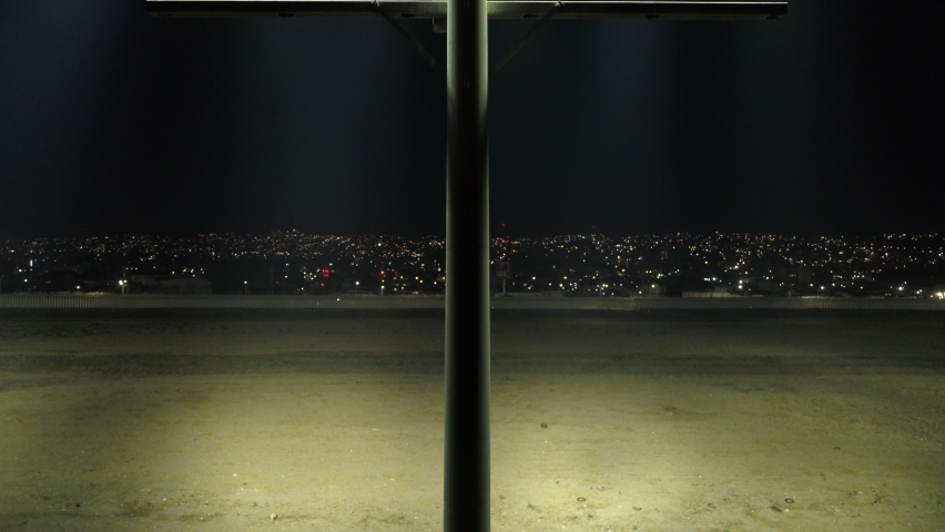 Border Security Flood Light, Empty Field In Between America and Mexico. Border Wall At Night. Border Security