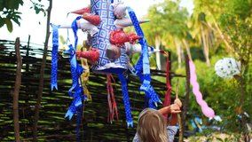 7 year old girl breaks a holiday pinata - Powered by Shutterstock - Get 15% off with code: PIKWIZARD15