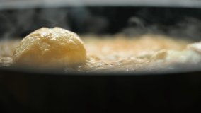 Cooking an cheese omelet in home kitchen. Macro view of fried omelette. Look for the whole process in my portfolio. UHD 4k video