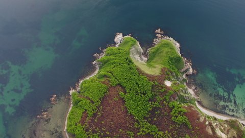 View from a drone vertically down on the rocks of Cape Kuzmin in the Gulf of Vladimir during the day. The sky is clouded over. Primorsky Territory, Russia