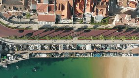 Cascais, Portugal, Europe. Beachfront road of a coastal town as seen from top. Drone footage of a coastal landscape washed with the sea. High quality 4k footage