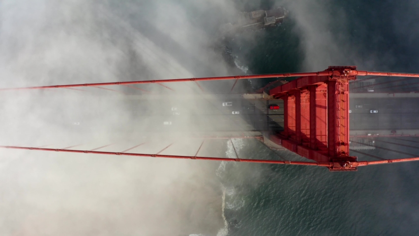 Cinematic Aerial drone footage of heavy fog surrounding the Golden Gate Bridge in San Francisco, California, USA  Royalty-Free Stock Footage #1076280281