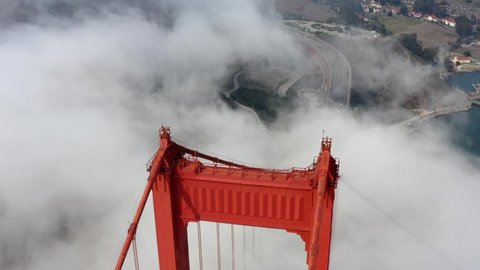 Cinematic Aerial drone footage of heavy fog surrounding the Golden Gate Bridge in San Francisco, California, USA 
