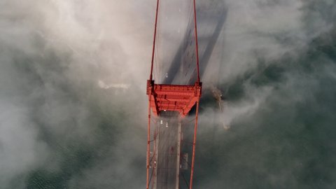 Cinematic Aerial drone footage of heavy fog blowing past the Golden Gate Bridge in San Francisco, California, USA