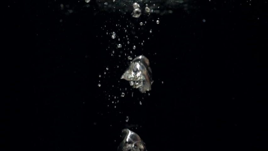 Slow motion air bubbles in water rising up to the surface on isolated black background. Slowmotion air bubbles floating under transparent water bubbles in aquarium | Shutterstock HD Video #1076290268