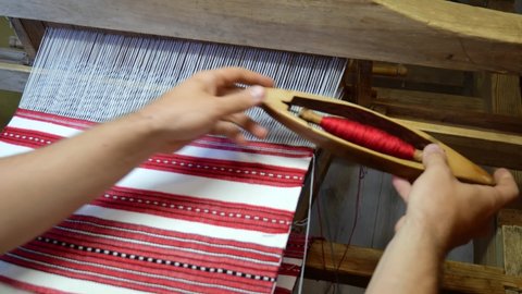 fabric making loom close-up. a man makes fabric on a satre wooden loom slow mo