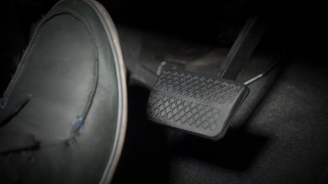 Accelerator and break pedal in a car. Close up the foot pressing foot pedal of a car to drive. Driver driving the car by pushing accelerator pedals of the cars. inside auto vehicle. Car foot pedal. 