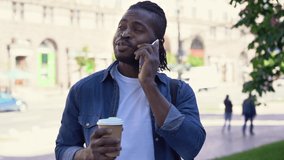 Handsome African man talking on mobile phone on the street, discussing something - Powered by Shutterstock - Get 15% off with code: PIKWIZARD15