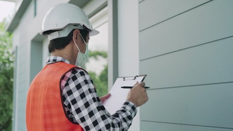 Engineers put on a mask during inspections to prevent the spread of the virus. Inspection engineers wear masks to reassure customers during home inspections. new home inspection concept.
