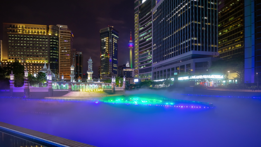 kuala lumpur city night time illuminated famous river fog central place panorama 4k timelapse malaysia