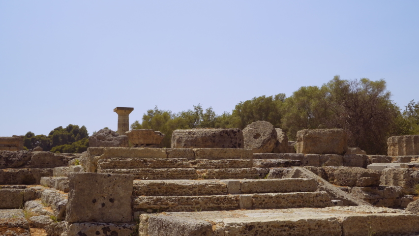 Olympia, Greece Archaeological site area that hosted the ancient sports Games. Remains of Doric Temple of Zeus with columns against blue sky.