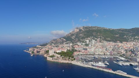 Monte Carlo, Monaco. Aerial view of famous city towering over Mediterranean Sea, yachts and boats in marina Port Hercules in La Condamine - landscape panorama of Europe from above