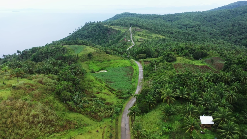 Winding Road Going Towards The Top Of Caningag Mountain In Southern Leyte In The Philippines. aerial Royalty-Free Stock Footage #1076314952