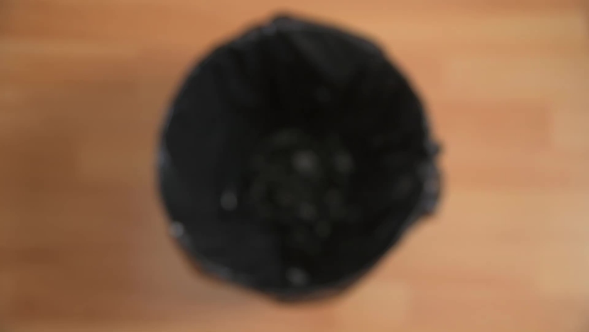 Aerial shot of dropping a disposable face mask into a bin to show lockdown restrictions easing and a return to normal Royalty-Free Stock Footage #1076322539