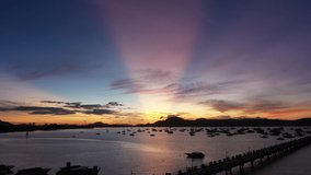 aerial view the pink sun shines through the sky over Chalong marina
4K video of Majestic sunrise landscape Amazing light of nature cloudscape sky above mountain range. 
colorful sky sunrise background.