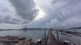 
time lapse cloudy above Chalong pier at sunrise.
4K video of Majestic sunrise landscape Amazing light of nature cloudscape sky above mountain range. 
boats yacht in Chalong marina gulf background.
