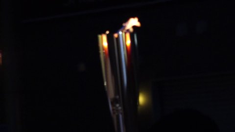 NUMAZU-SHI, SHIZUOKA, JAPAN - 24 JUNE 2021 : Tokyo 2020 Olympic Torch Relay at Numazu-shi area. View of close up shot of torch fire. Slow motion shot.