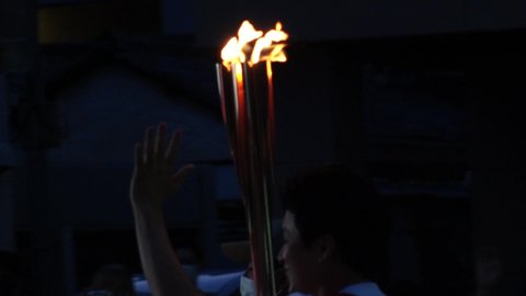 NUMAZU-SHI, SHIZUOKA, JAPAN - 24 JUNE 2021 : Tokyo 2020 Olympic Torch Relay at Numazu-shi area. View of close up shot of torch fire. Slow motion shot.